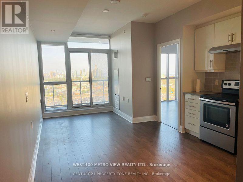 A real estate listing photo of a kitchen and living room.