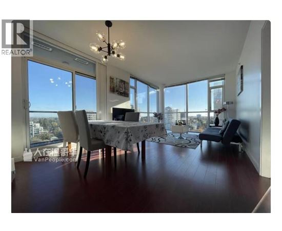 A dining room with a table set for two and a view of the city.