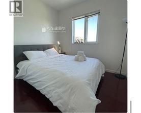 A bedroom with a large bed and a window with the word LOVE written on it.