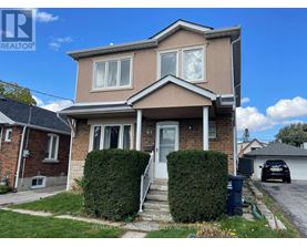 A house with a white door and windows is for sale.