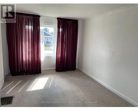 A room with red curtains and a carpeted floor.