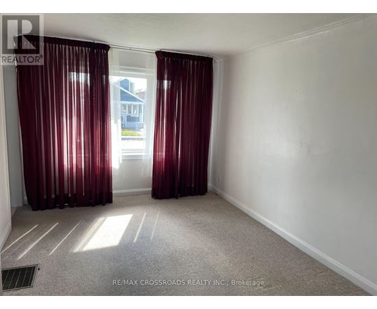 A room with red curtains and a carpeted floor.