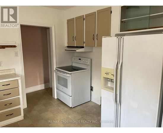 A kitchen with a white fridge, white oven and white microwave.