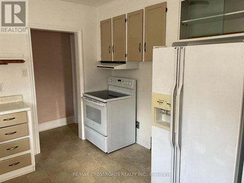 A kitchen with a white fridge, white oven and white microwave.