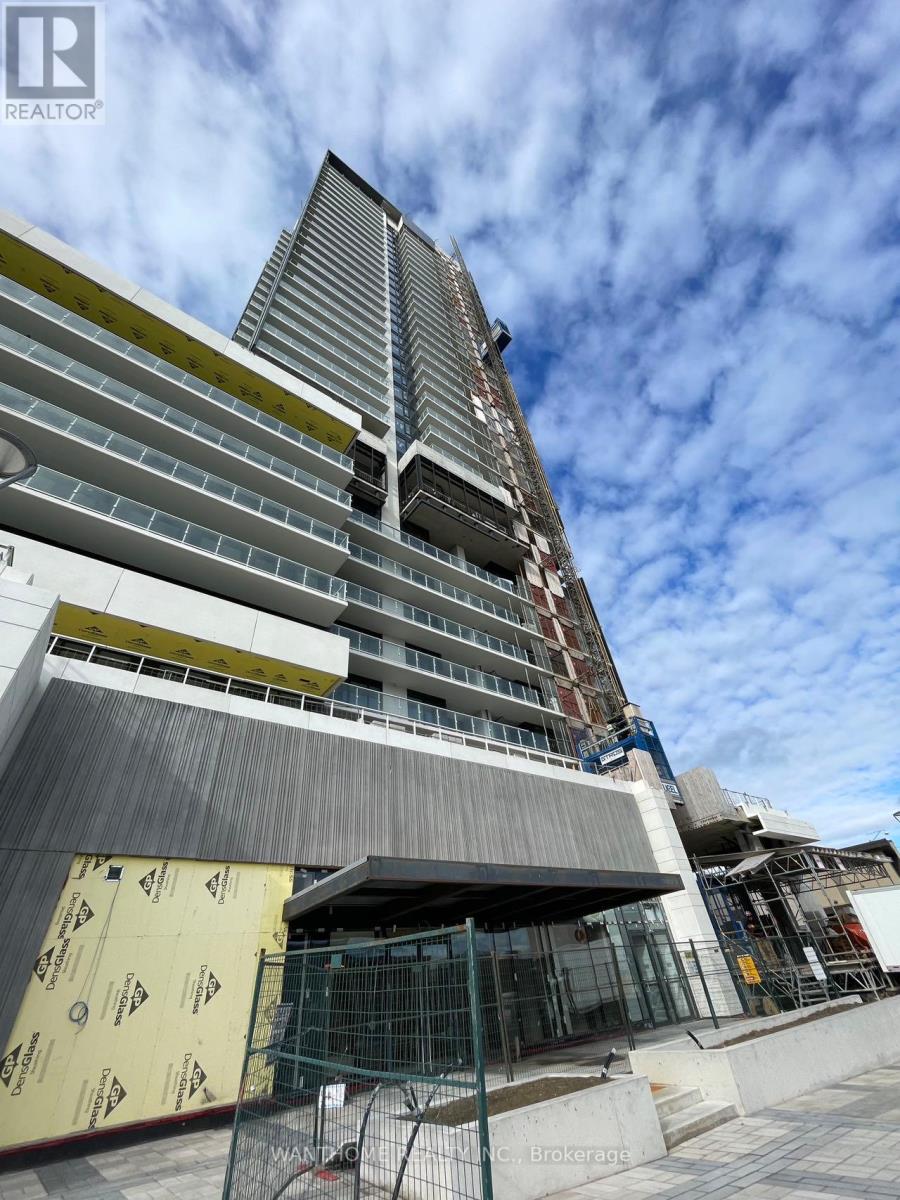 A building under construction with a blue sky in the background.