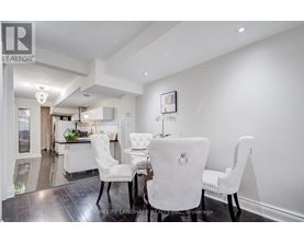 A dining room with a table set for four.