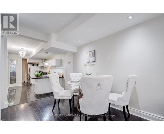 A dining room with a table set for four.