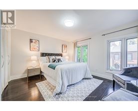 A bedroom with a large bed and a window.