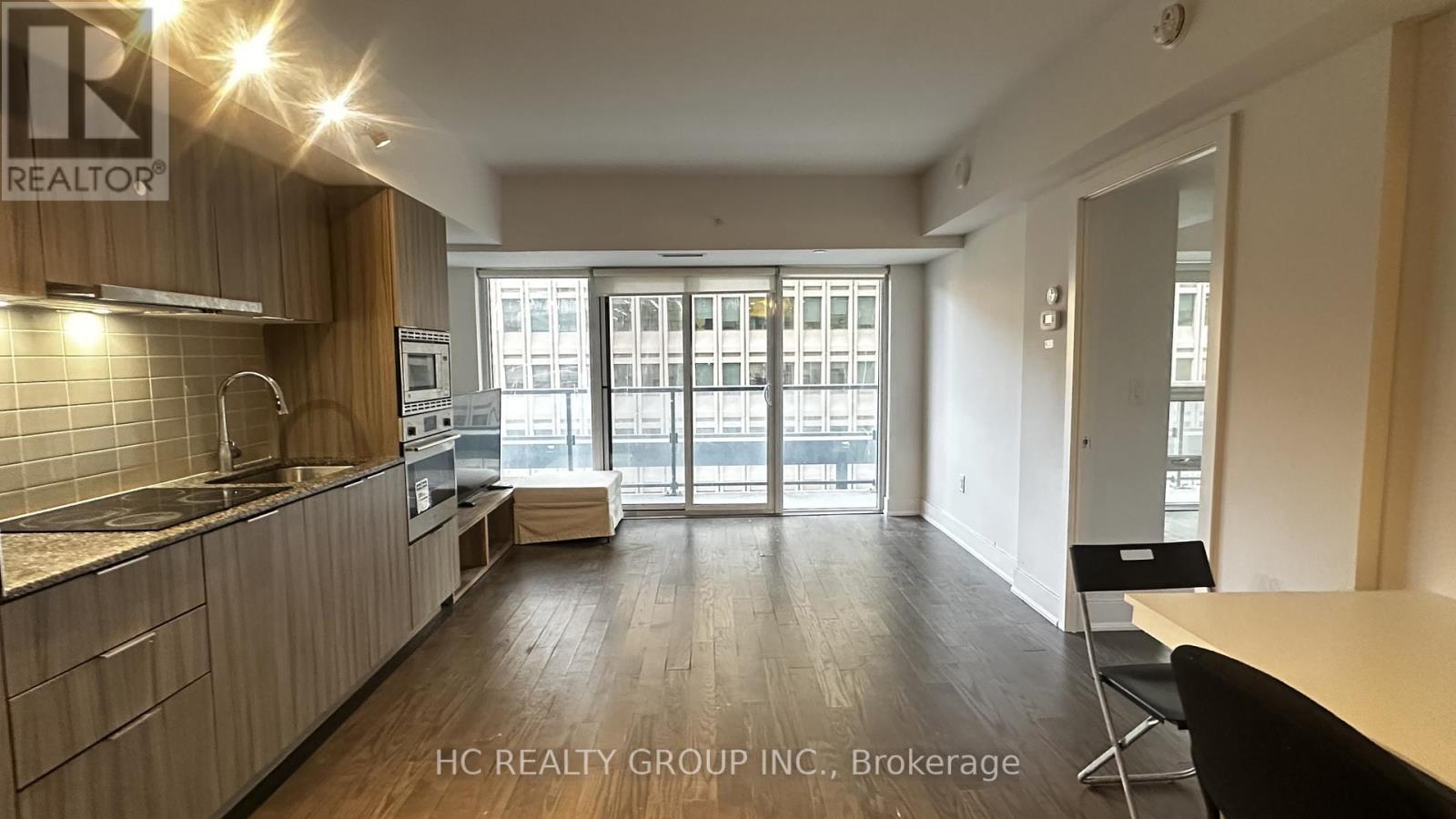 A kitchen with a counter and chairs with a sign that says REALTOR.