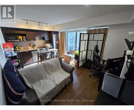 A living room with a couch and a dining table.