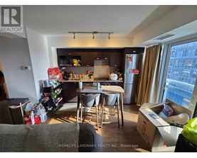 A kitchen with a table and chairs in front of a window.