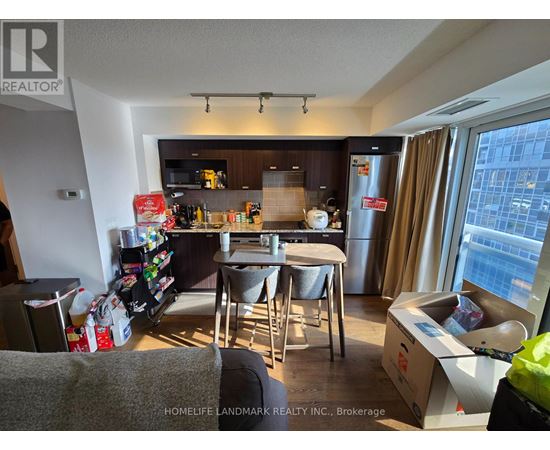 A kitchen with a table and chairs in front of a window.