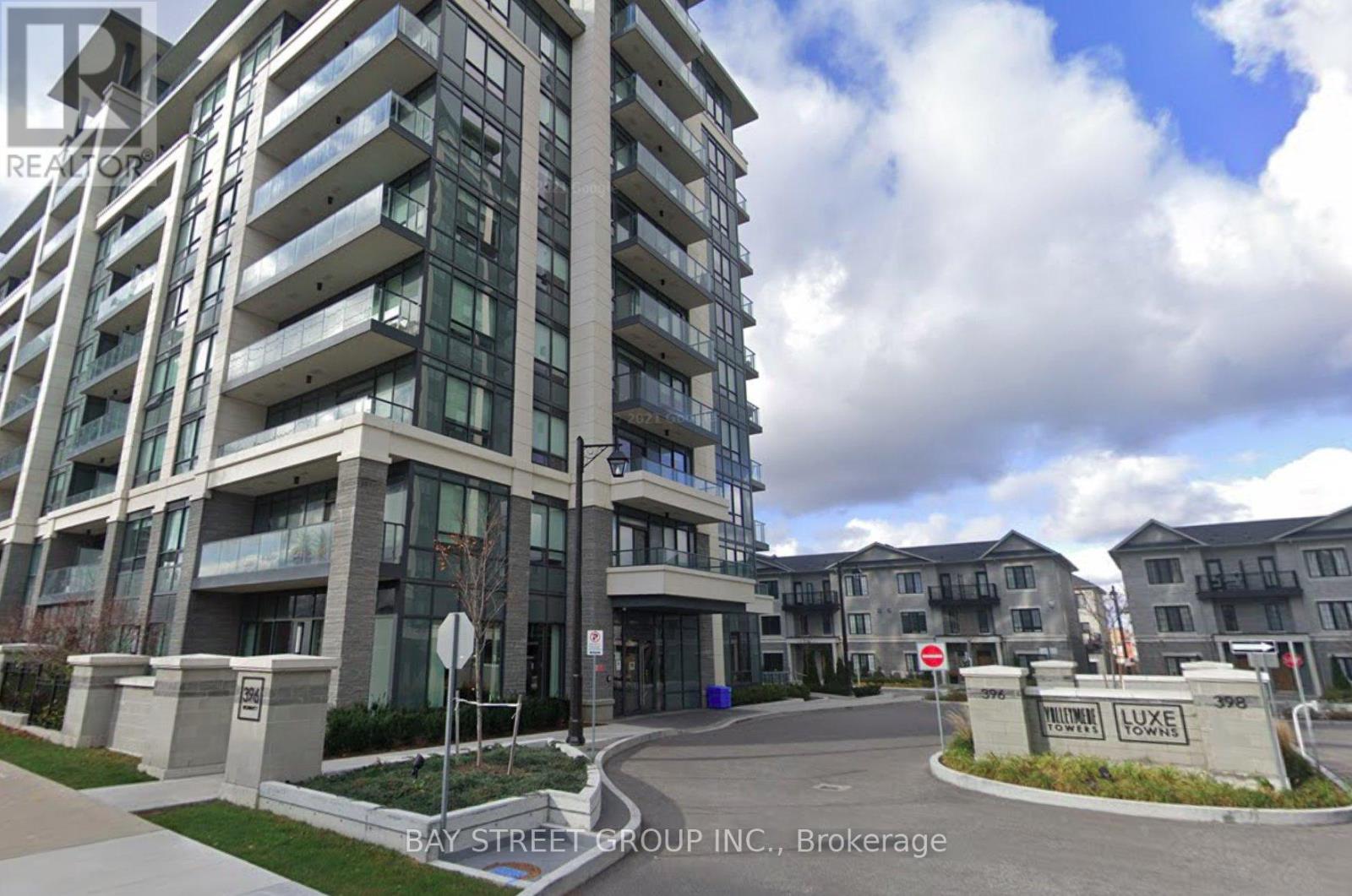 A modern apartment building with a sign that reads "Bay Street Group Inc., Brokerage.".