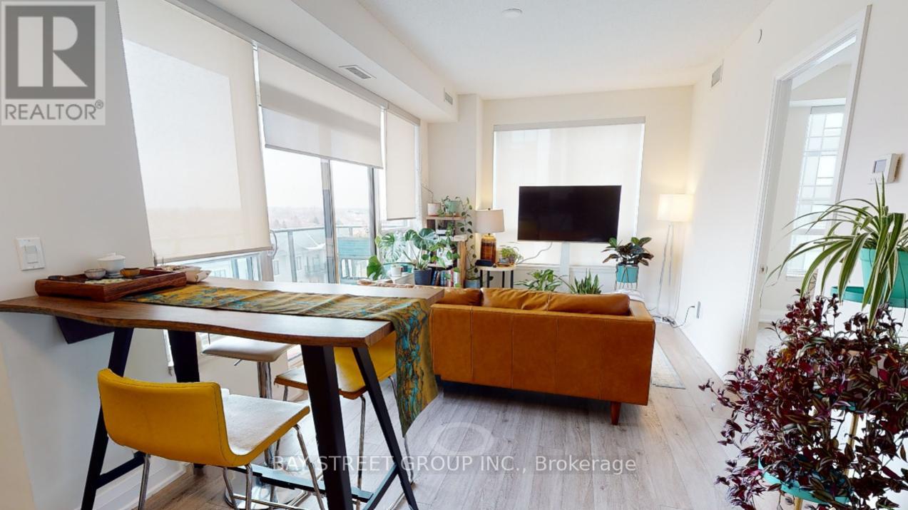 A living room with a couch, a table, and a television.