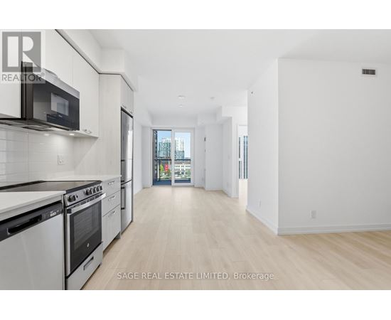 A white kitchen with a black microwave and stove.