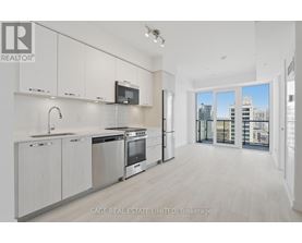 A modern kitchen with white cabinets and stainless steel appliances.