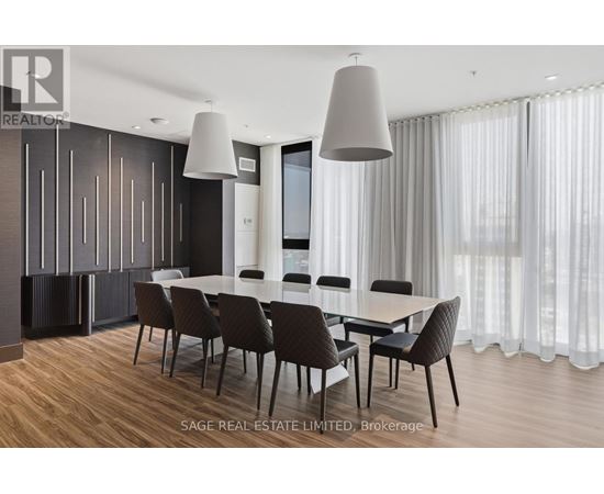A modern dining room with a large table and chairs.