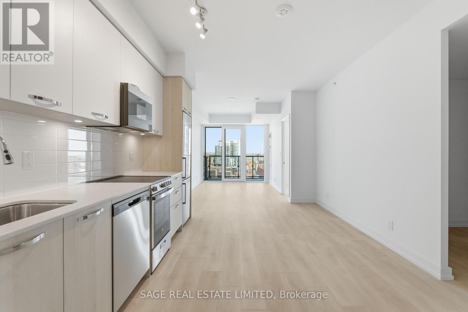 A modern kitchen with stainless steel appliances and wooden cabinets.