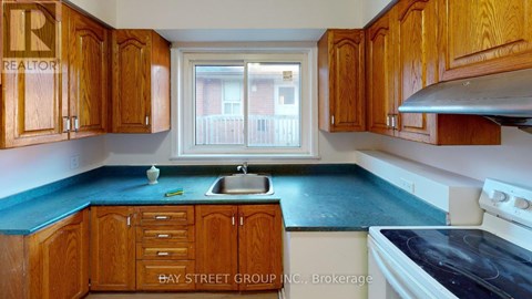 A kitchen with wooden cabinets and a blue countertop.
