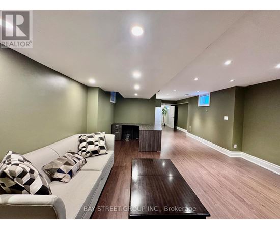 A living room with a white couch and a wooden coffee table.