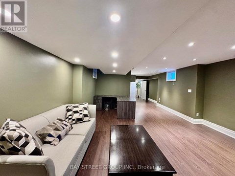 A living room with a white couch and a wooden coffee table.