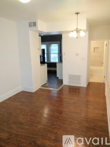 A room with wooden floors and a chandelier.