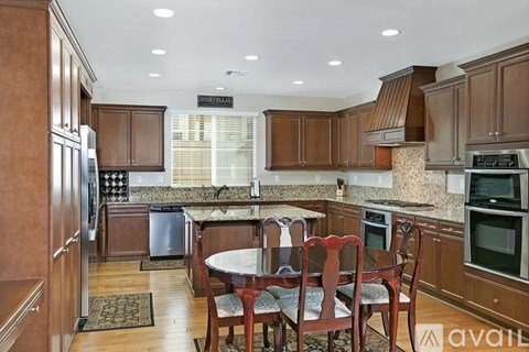 A kitchen with brown cabinets and a table set for four.