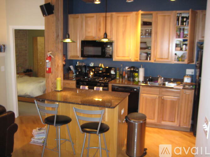 A kitchen with a table and chairs.