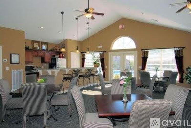 A dining room with a table set for six people.