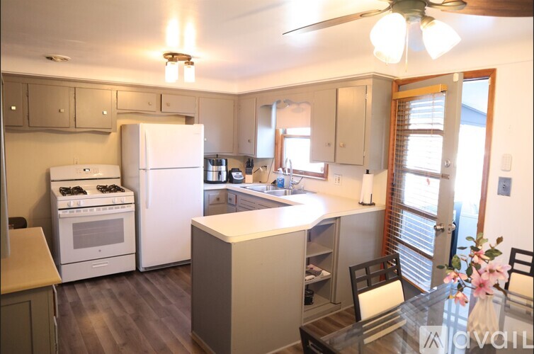 A kitchen with a white refrigerator and a white stove.