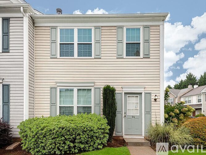 A house with a grey door and windows is for sale.