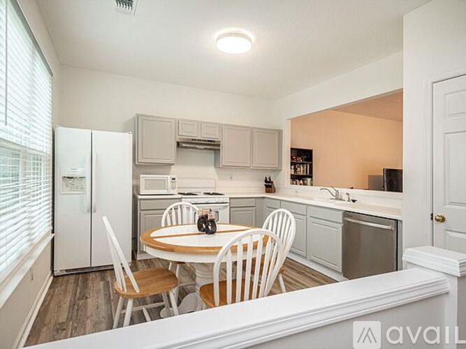 A kitchen with a table and chairs in the middle of the room.