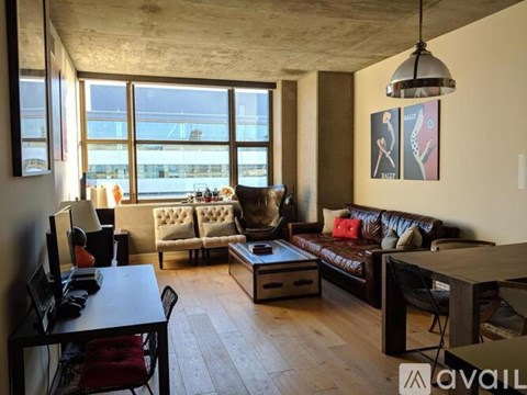 A living room with a brown leather couch and a wooden coffee table.