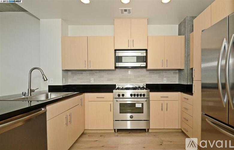 A kitchen with a stove top oven and a microwave above it.