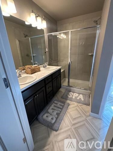 A bathroom with a spa mat on the floor.