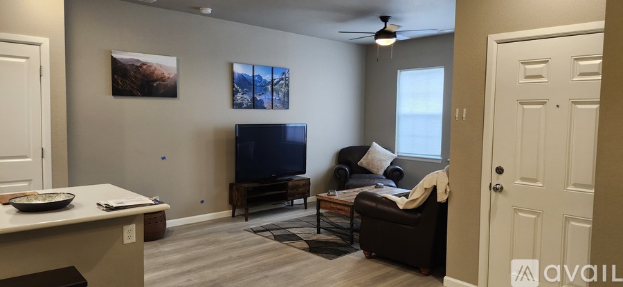 A living room with a television and a couch.