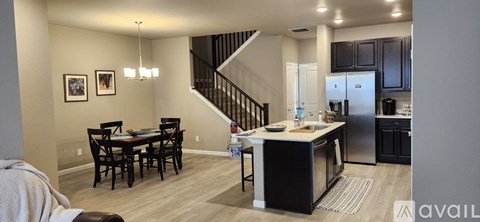 A kitchen with a dining table and chairs is available for rent.