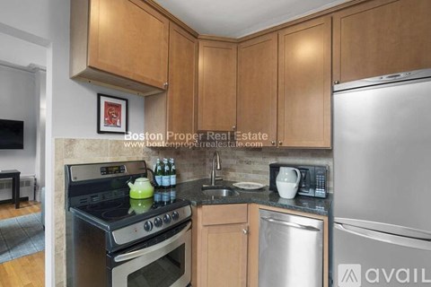 A kitchen with wooden cabinets and a stainless steel dishwasher.