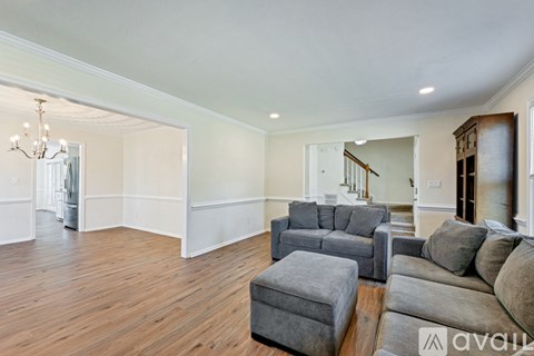 A living room with a grey sofa and ottoman.