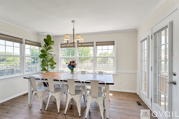 A dining room with a table and chairs.