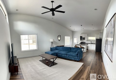A living room with a blue couch and a television.