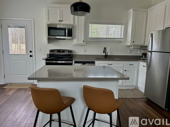 A kitchen with a stove top oven and a refrigerator.