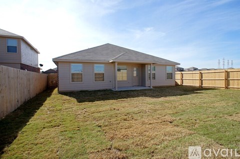 A house with a fence and grass in front is available for rent.