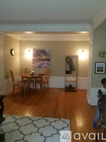 A dining room with a table and chairs.