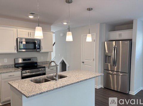 A kitchen with granite countertops and stainless steel appliances.