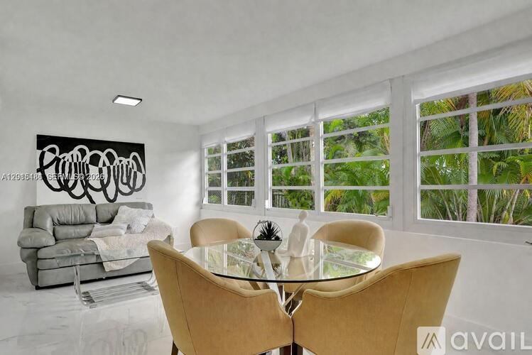 A dining room with a glass table and chairs.