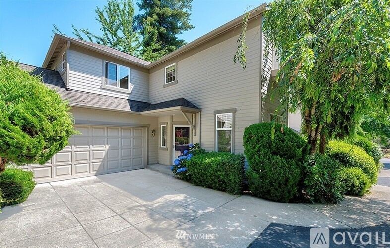 A house with a garage and a driveway is for sale.