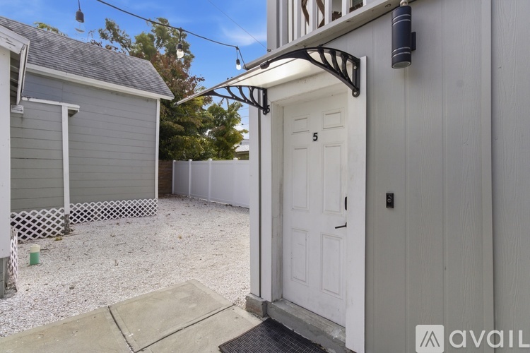 A white door with a black handle is on the right side of the image.