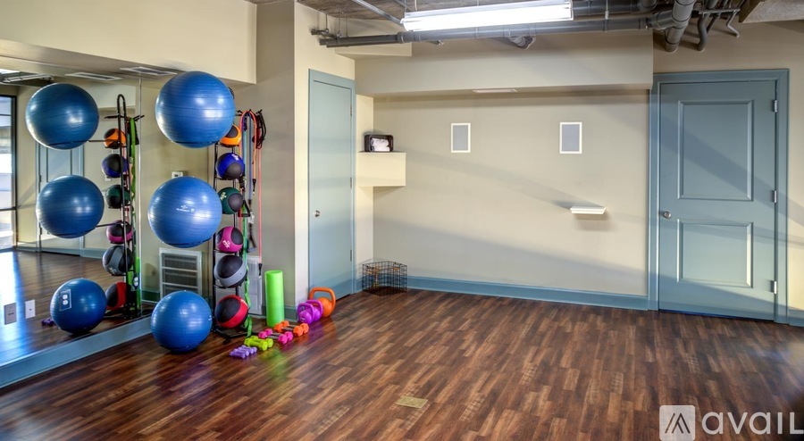 A gym room with exercise balls and other equipment.