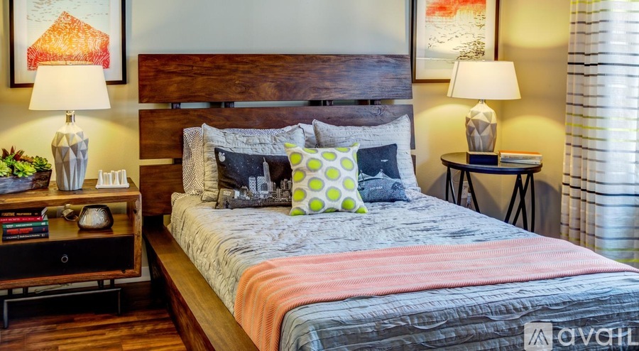 A bedroom with a large bed and a wooden headboard.